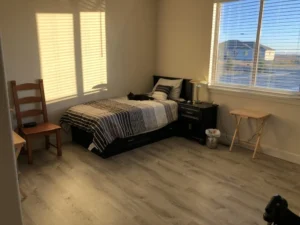 Cozy private bedroom at Adult Family Center of Moses Lake, providing affordable senior care and seniors foster care in Washington State with bright, accessible housing.